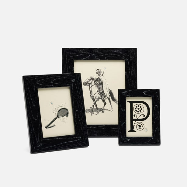 Three black-framed pictures with different designs on a white background