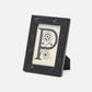 Black photo frame with decorative letter 'P' on a white background