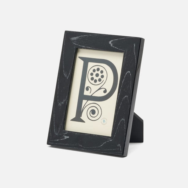 Black photo frame with decorative letter 'P' on a white background