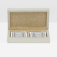 Open beige fabric box with playing cards on a white background