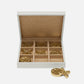 Open jewelry box with gold butterfly-shaped pendants on a white background