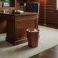 Brown leather bucket with handles in a home office