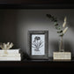 A small rectangular picture frame with a textured dark gray shagreen border, holding a white card with a black-and-white botanical illustration and the text 'Pigeon & Poole'.