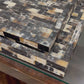 hammered horn trays stacked in a showroom