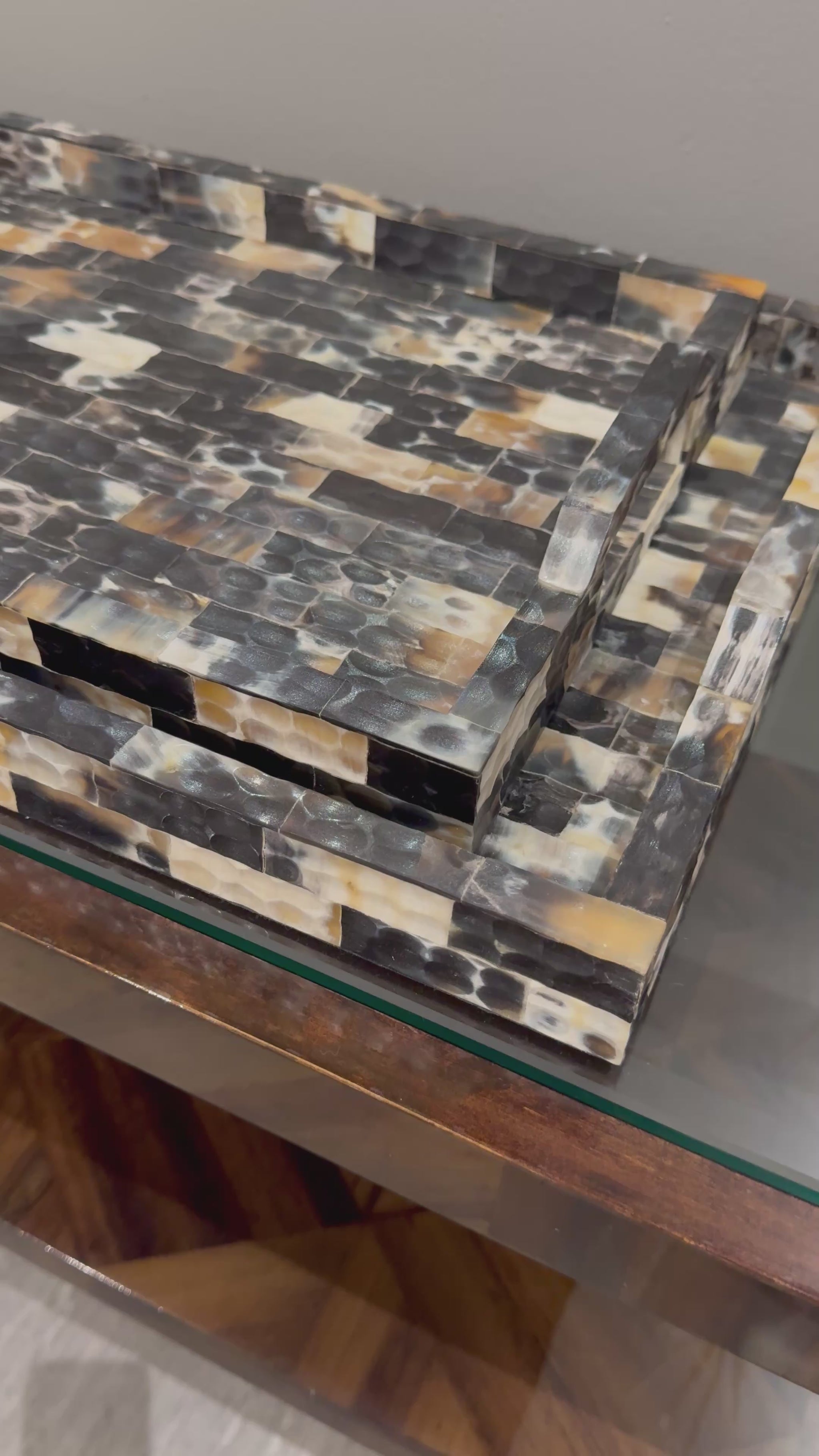 hammered horn trays stacked in a showroom