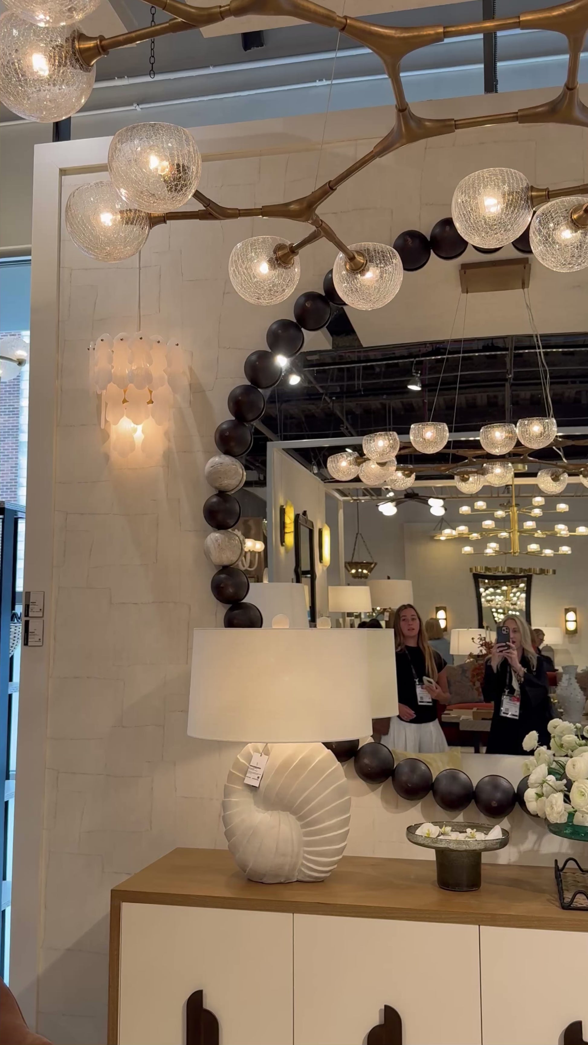 video of a showroom showcasing a wooden bead large round mirror