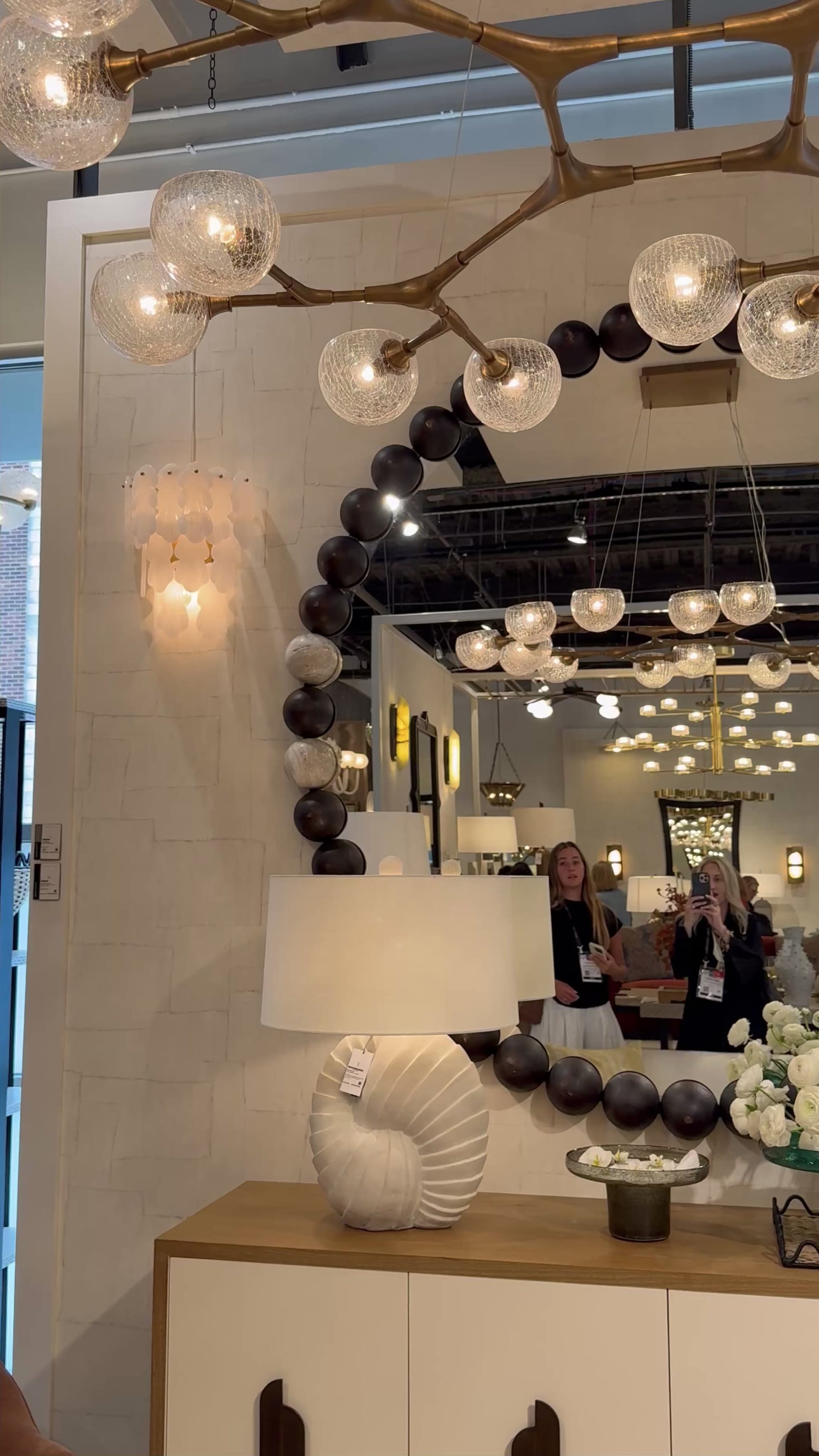 video of a showroom showcasing a wooden bead large round mirror