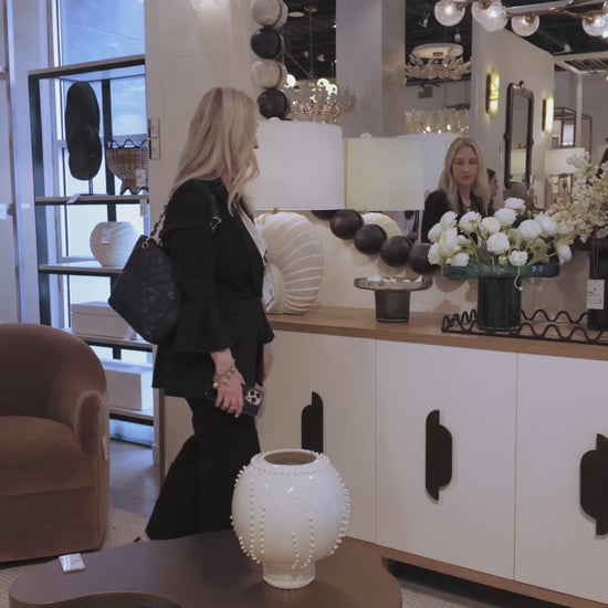 video of a showroom showcasing a wooden bead large round mirror