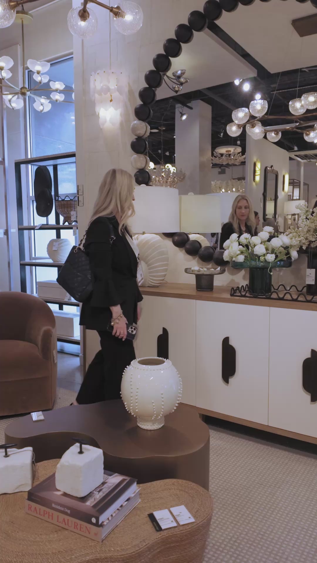 video of a showroom showcasing a wooden bead large round mirror