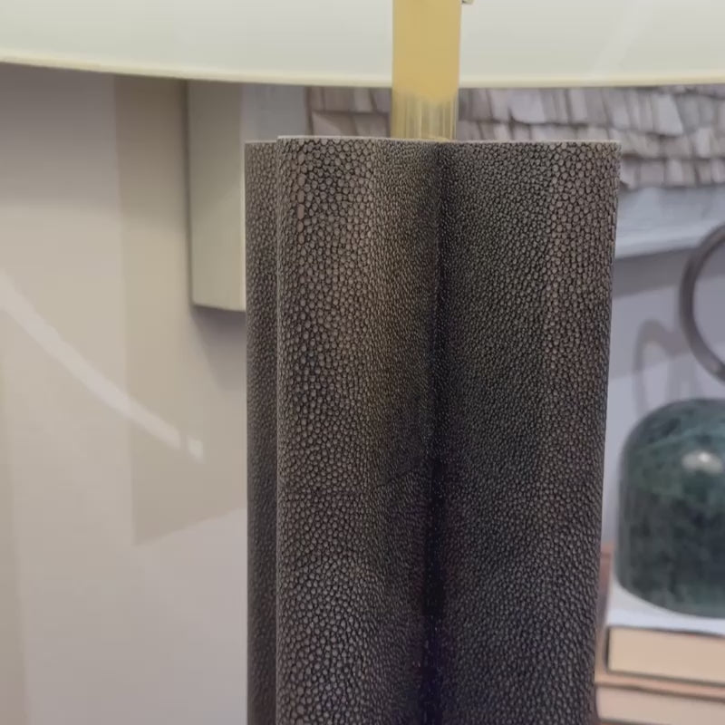 realistic faux shagreen table lamp in dark mushroom in a showroom
