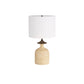 Table lamp with a textured beige base and white shade on a white background