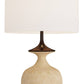 Table lamp with a beige base and white shade on a white background