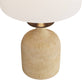 Beige ceramic table lamp with a white lampshade on a white background