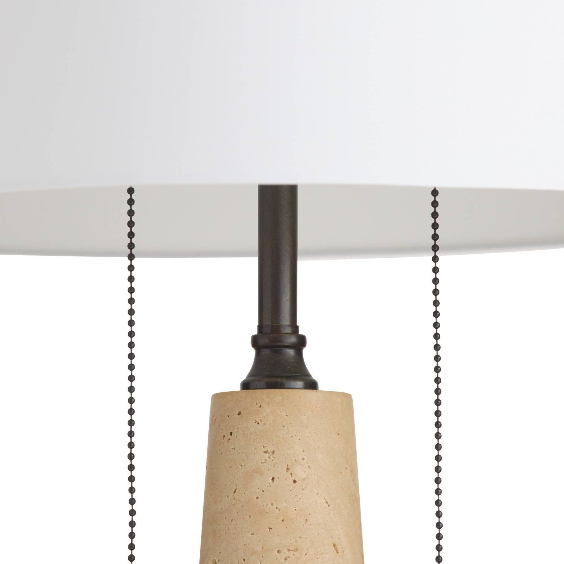 Close-up of a pendant light with a concrete base and black pull chain on a white background