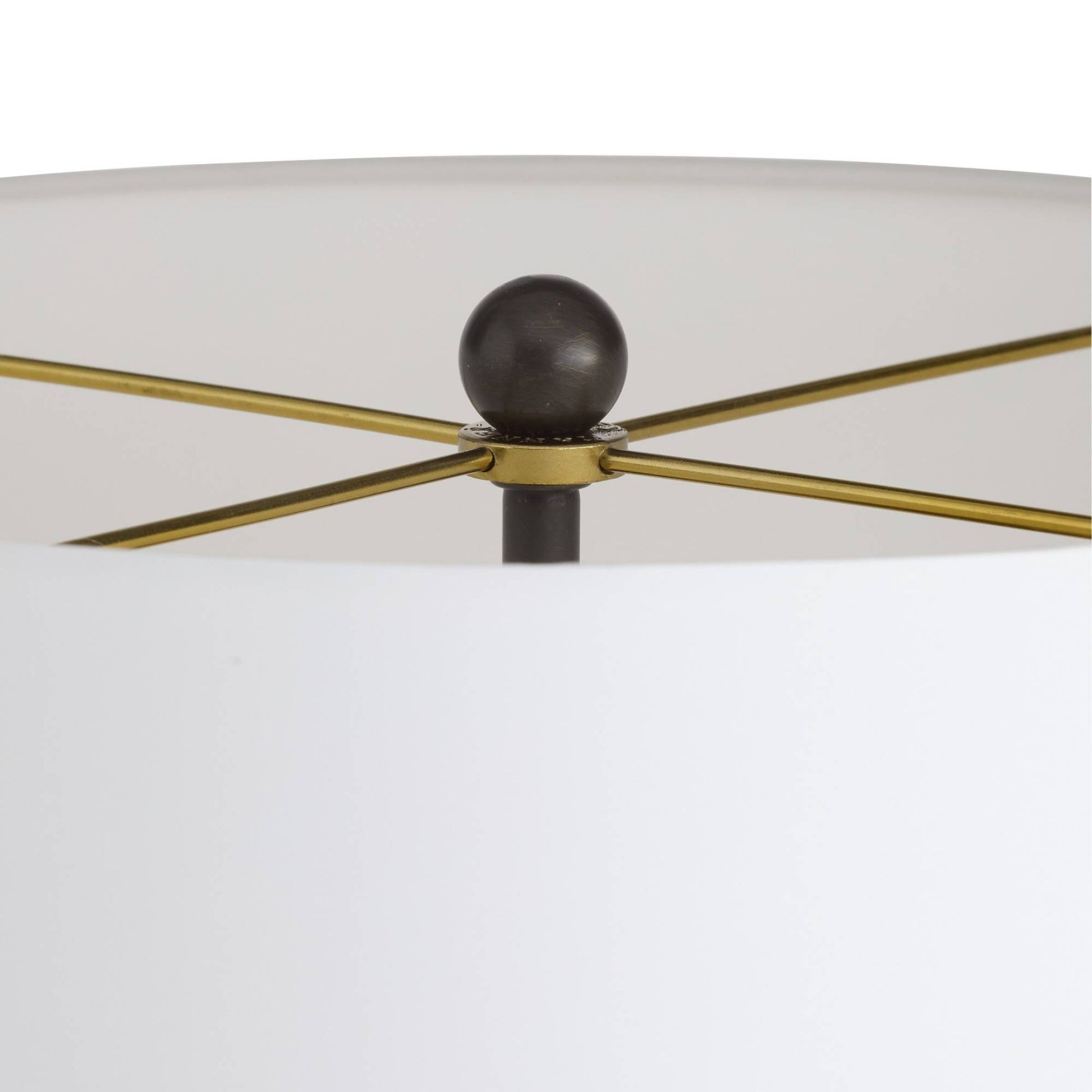Close-up of a ceiling fan with gold blades and black central hub on a white background