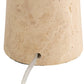 Close-up of a tapered stone or travertine-style lampshade in a warm beige/tan color, showing the textured surface and a small circular opening at the base from which a white cord exits.