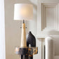 Decorative lamp with a unique design on a side table in a room setting.