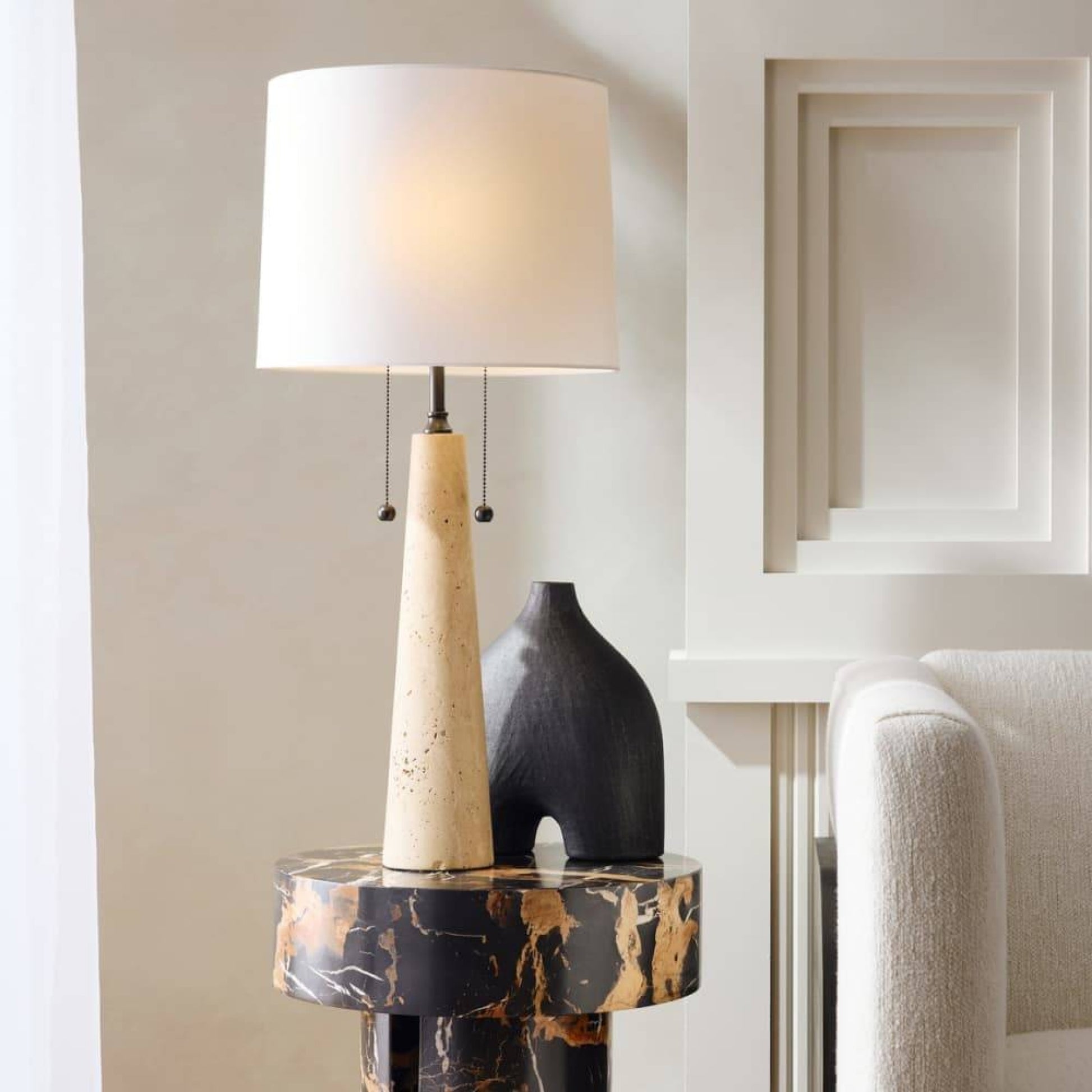 Decorative lamp with a unique design on a side table in a room setting.