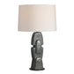 Table lamp with textured base and white shade on a white background