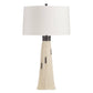 Table lamp with a white shade and beige base on a white background