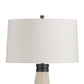 Table lamp with a white shade and black base on a white background