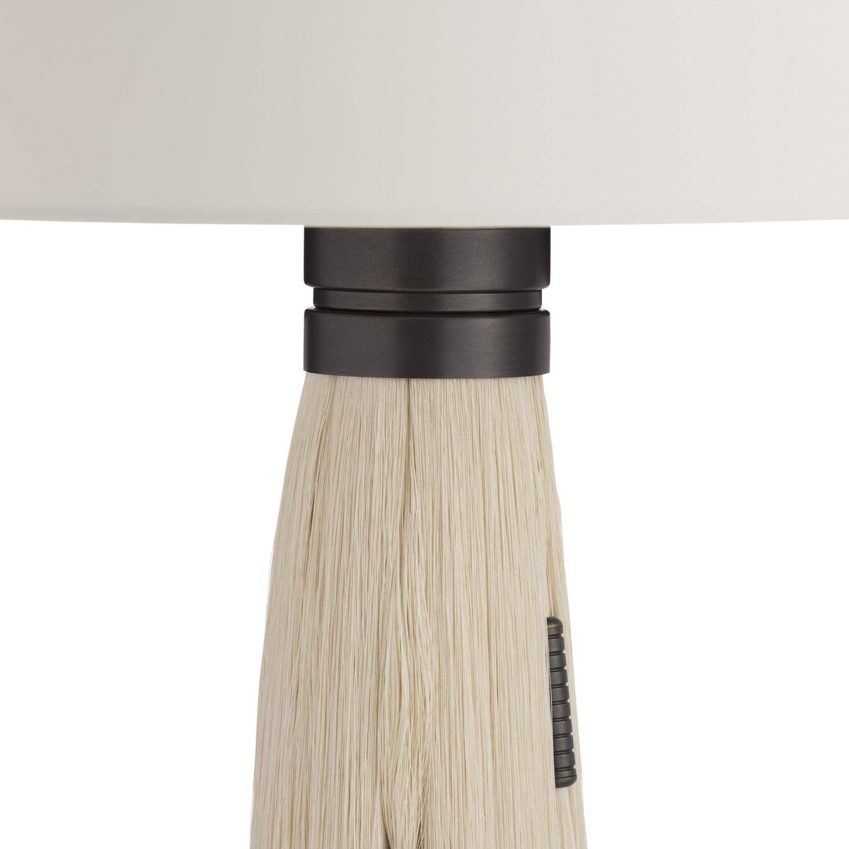 Close-up of a table lamp with a black handle against a white background