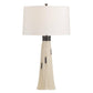 Table lamp with a white shade and beige tassel on a white background