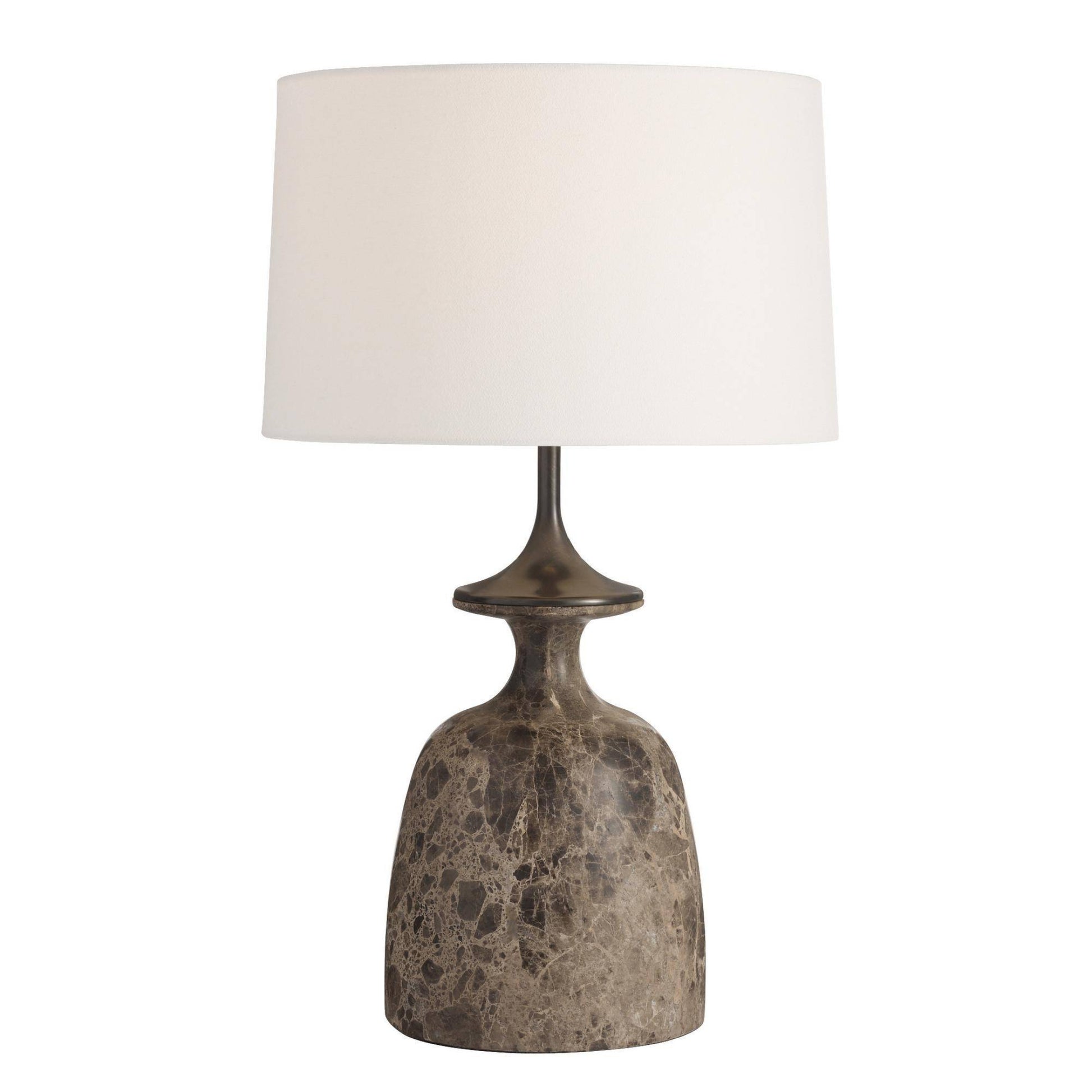 Table lamp with a textured base and white shade on a white background
