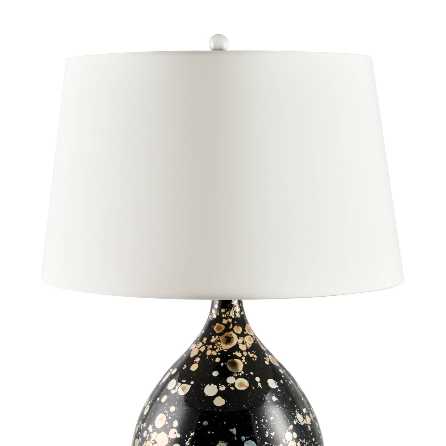 Decorative table lamp with a black base featuring gold speckles and a white shade on a white background.