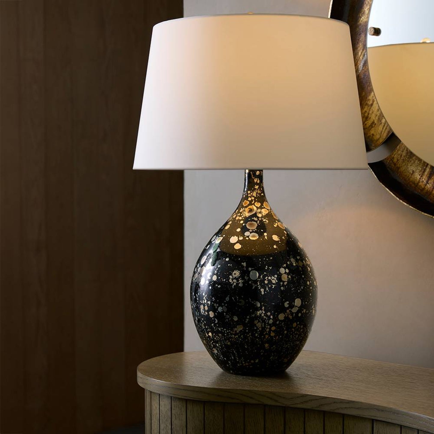 Table lamp with a decorative base on a wooden surface