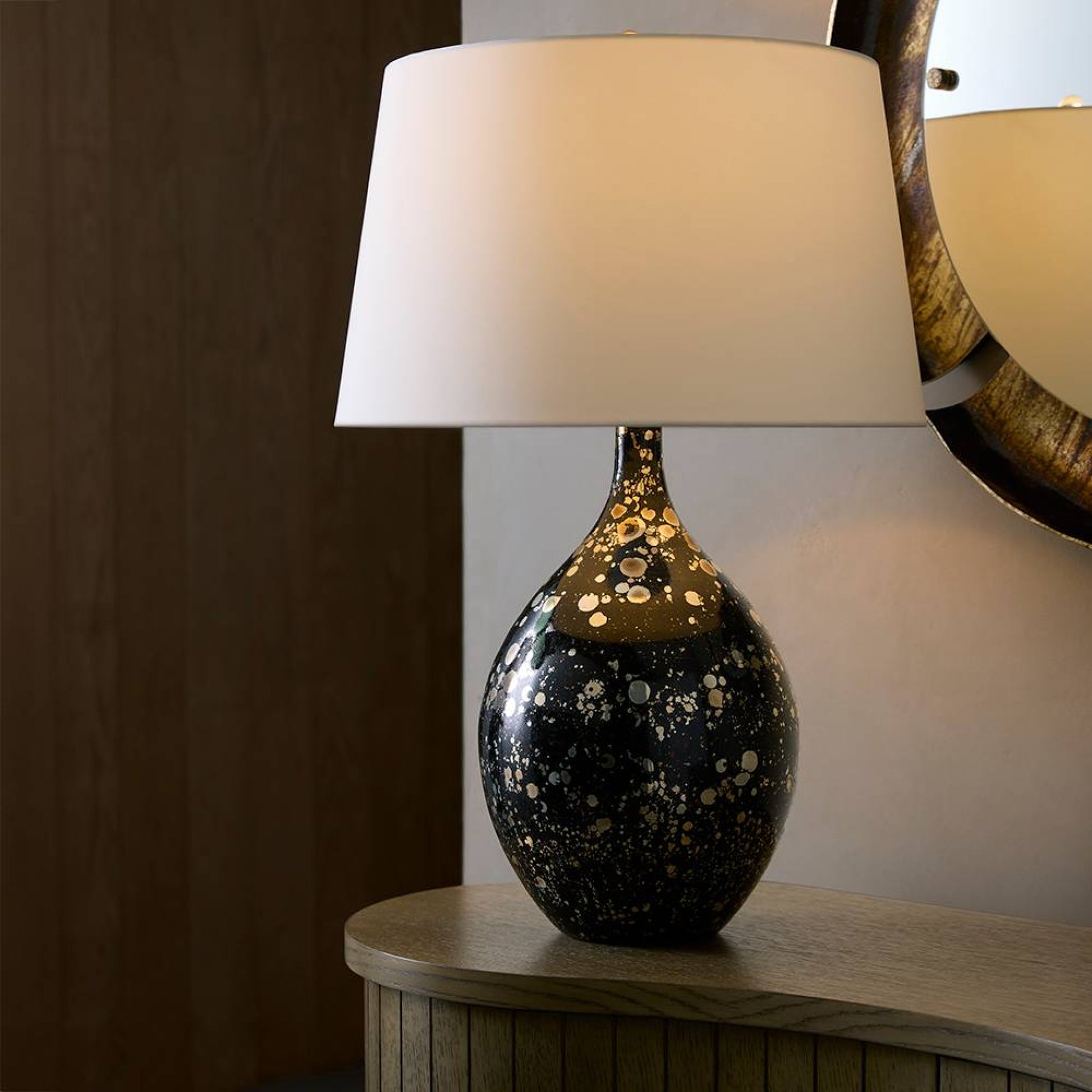 Table lamp with a decorative base on a wooden surface