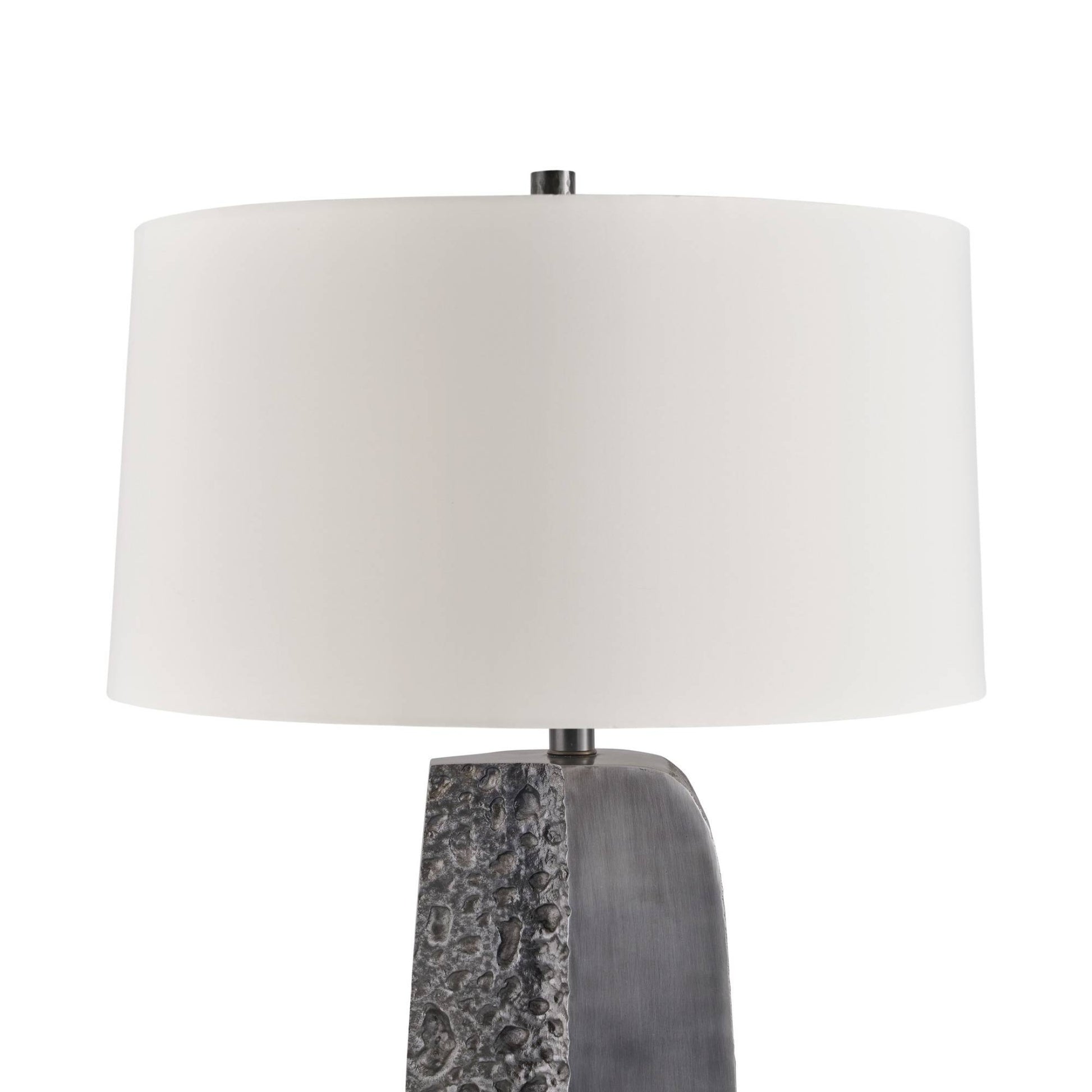 A table lamp with a large white drum shade and a textured gray stone base, shown against a plain white background.