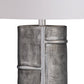 Textured metallic lamp base on a white background