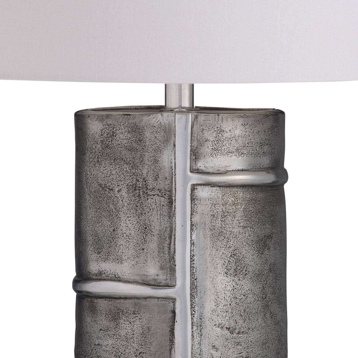 Textured metallic lamp base on a white background