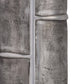Close-up of textured metal pipes on a white background