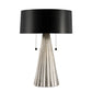 Table lamp with black shade and metallic base on a white background