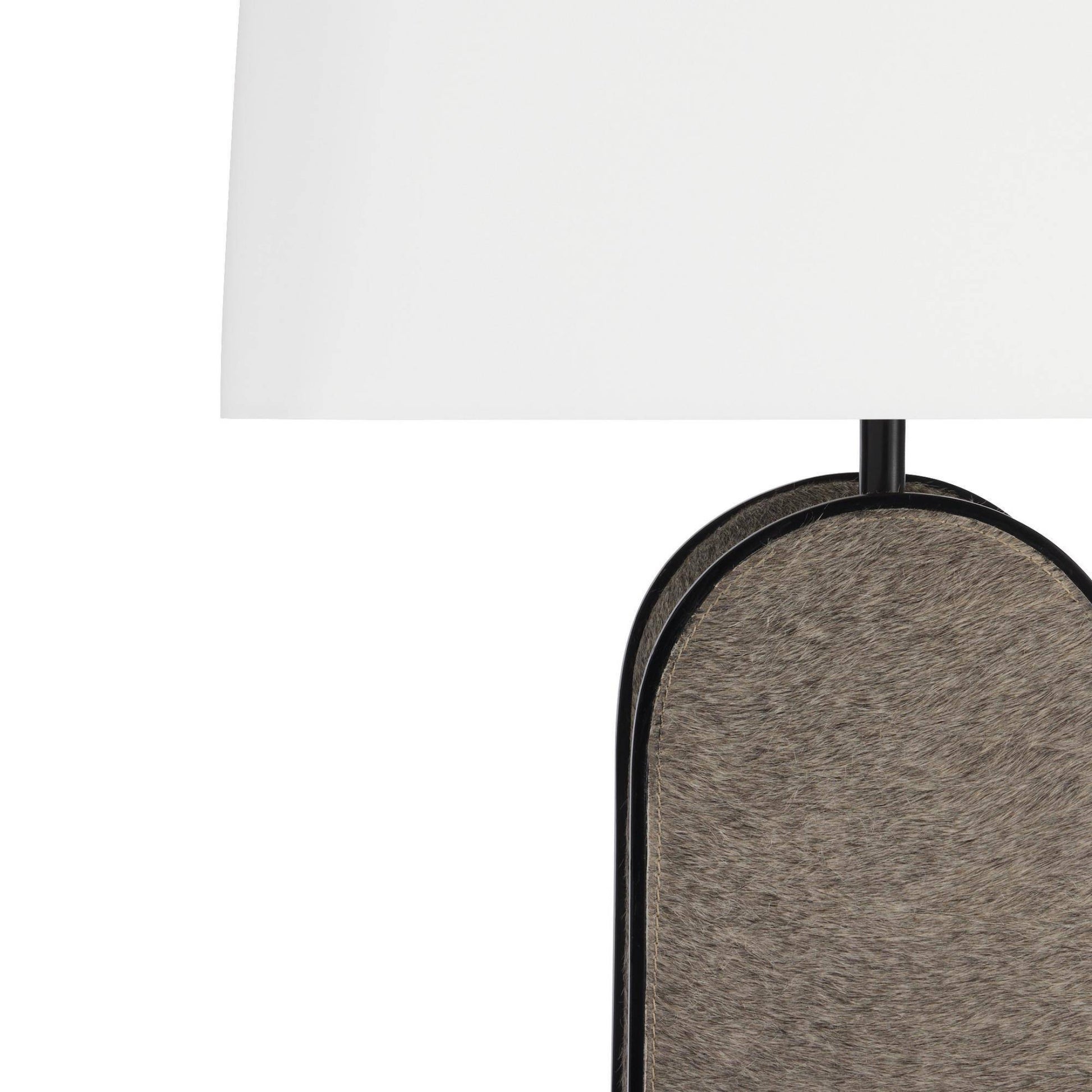 Close-up of a table lamp with a white rectangular shade and a dark metal frame holding a textured taupe-gray oval lamp base, shown against a white background.
