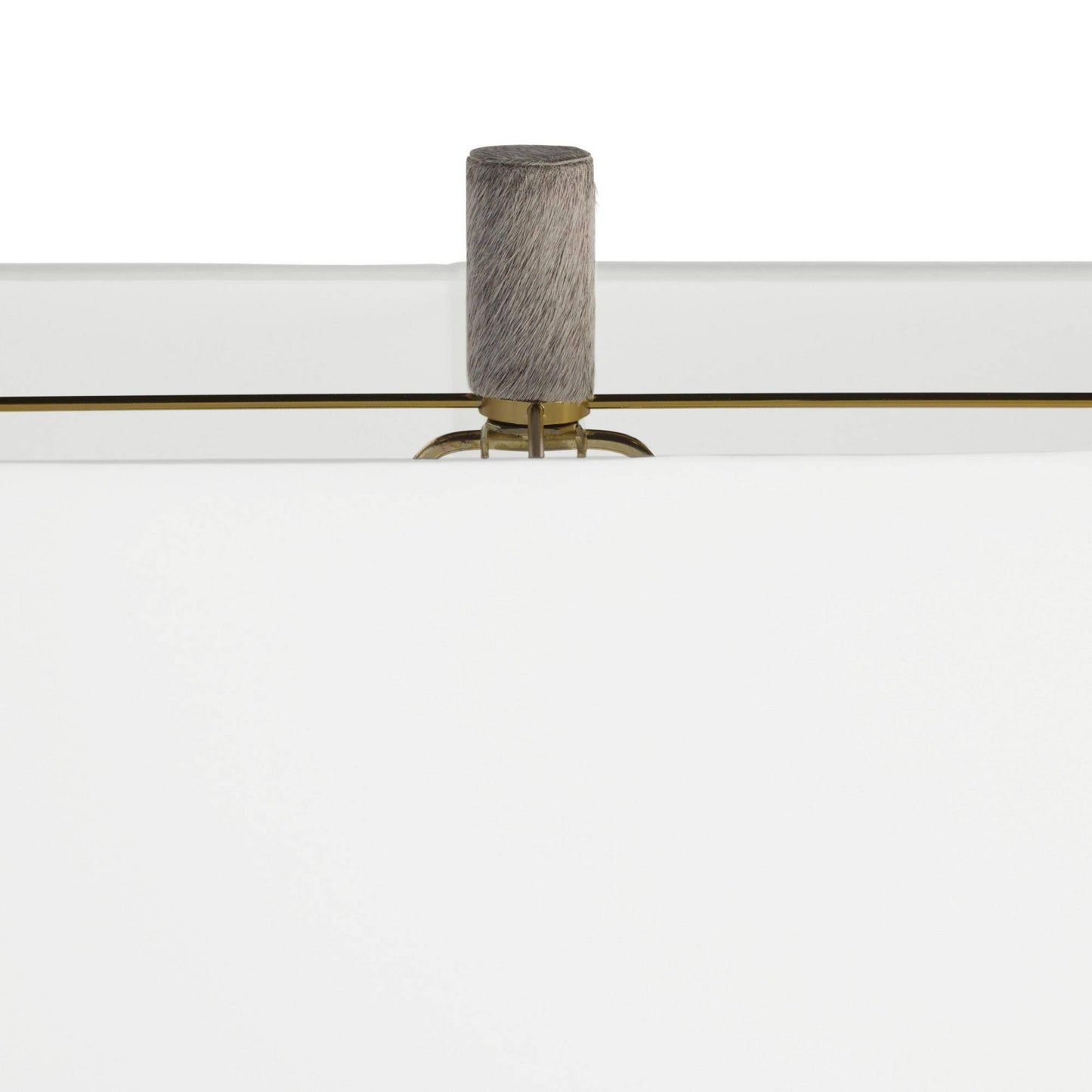 Close-up of a modern white furniture piece with a cylindrical gray textured handle and a thin gold horizontal accent line.