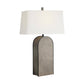 Table lamp with a textured gray base and white shade on a white background