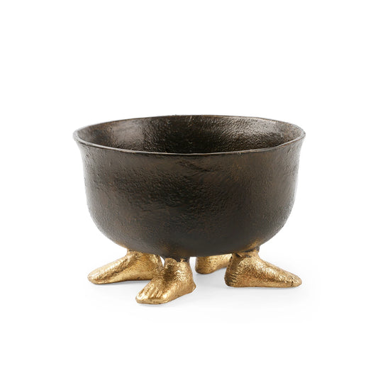 A decorative cast-iron bowl with a textured dark brown finish and three small metallic gold feet, shown on a plain white background.