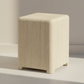 Beige cube-shaped stool on a neutral background