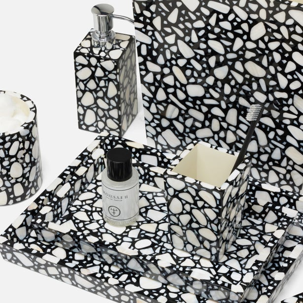 Bathroom set with black and white terrazzo pattern including soap dispenser, toothbrush holder, and bottle.