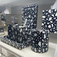 Bathroom accessories with black and white pattern on a shelf