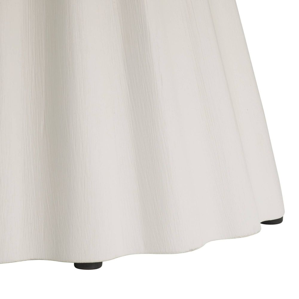 Close-up of a white skirt with a plain background