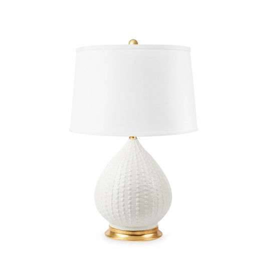 A table lamp with a textured white teardrop-shaped ceramic base, a white drum shade, and polished gold-finished metal accents at the top finial, neck, and bottom ring, shown on a plain white background.