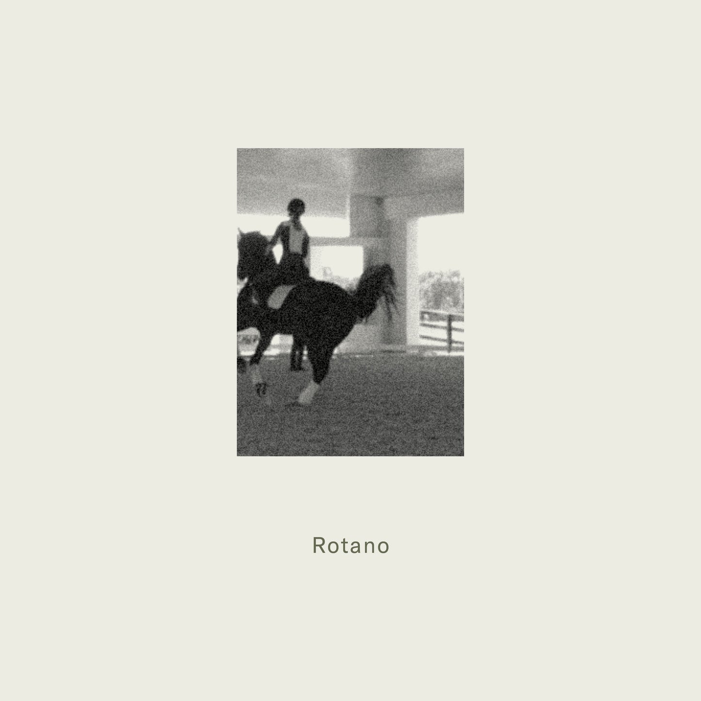 Person riding a horse in an indoor arena with 'Rotano' text below.