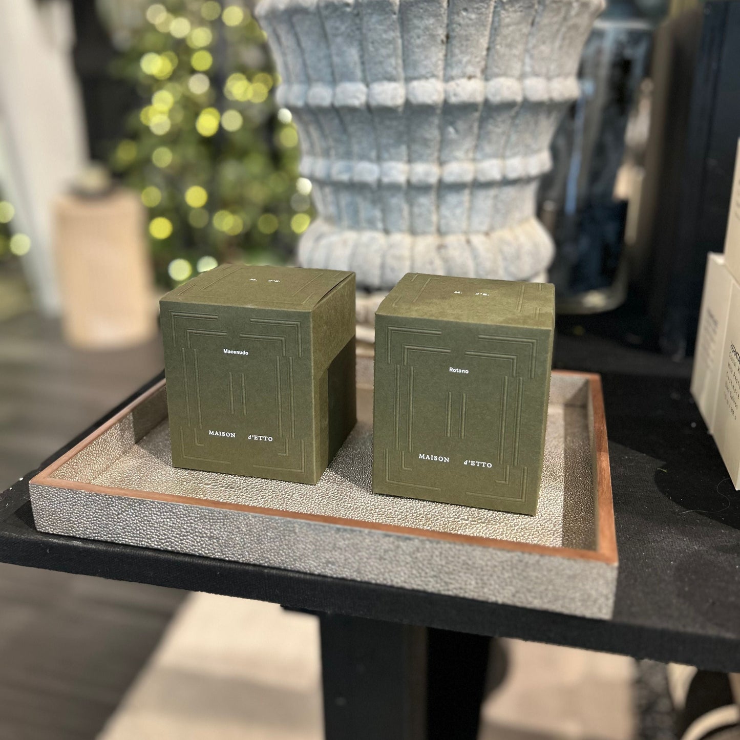 Two green boxes on a wooden stand with a blurred background