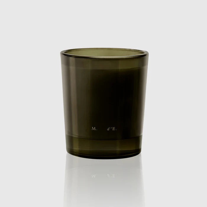 Dark green glass candle holder on a white background