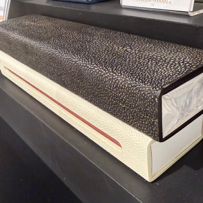 Textured rectangular object on a dark surface with a blurred background