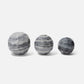 Three gray marble spheres on a white background